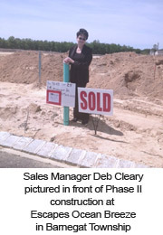 Sales Manager Deb Cleary pictured in front of Phase II construction at Escapes Ocean Breeze in Barnegat Township